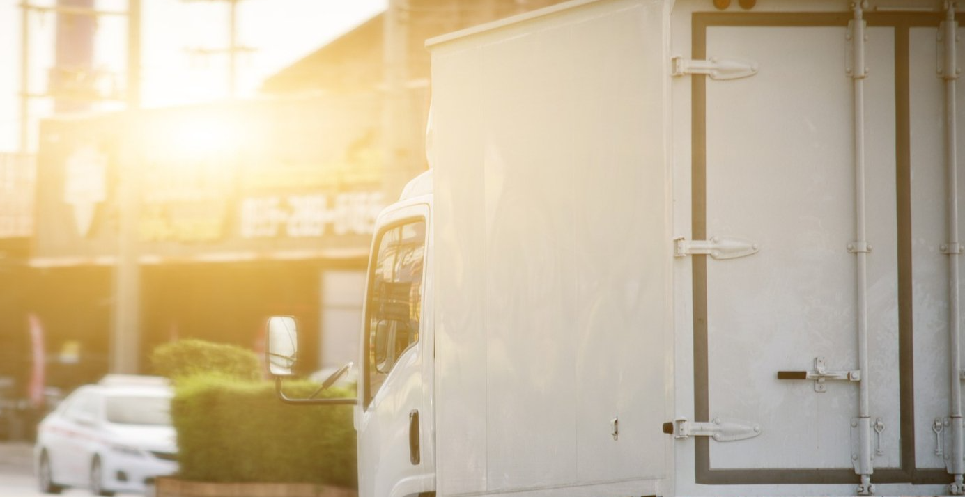 image of a box truck riding off into the sunset
