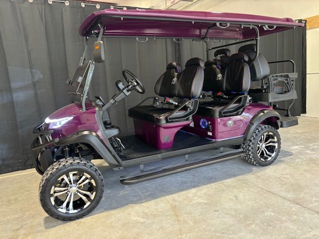 Purple golf cart with four seats and black canopy parked outdoors