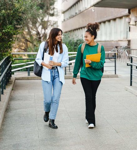 Safewell Personal Safety and Wellness App. Social Safety App for Students. Two college students on campus.
