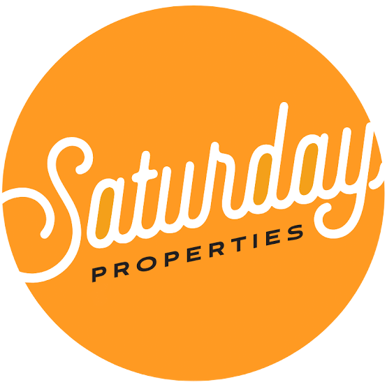 Orange circle with white script "Saturday Properties" and smaller text "PROPERTIES."