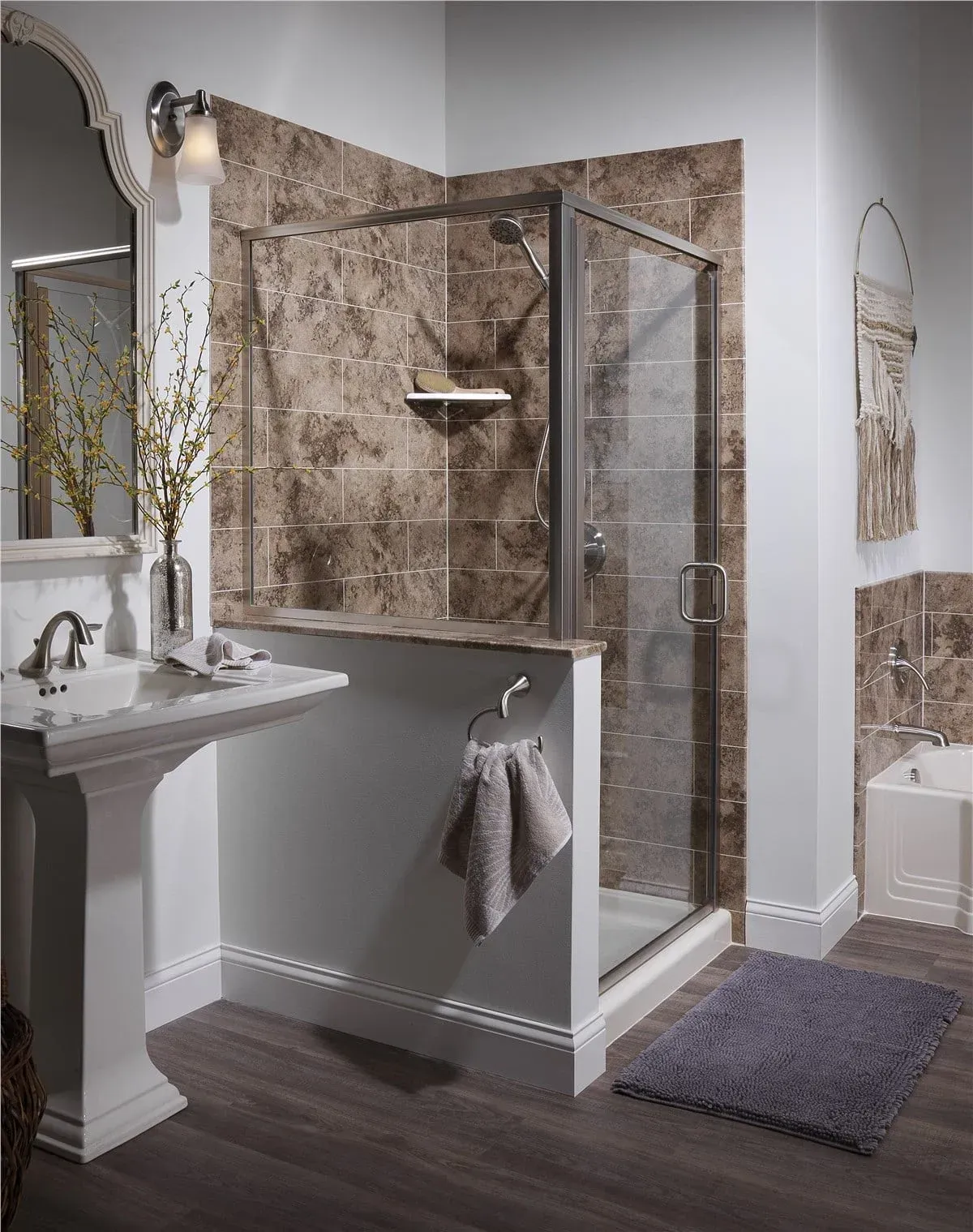 Modern bathroom with a glass shower, pedestal sink, gray walls, and tiled floor