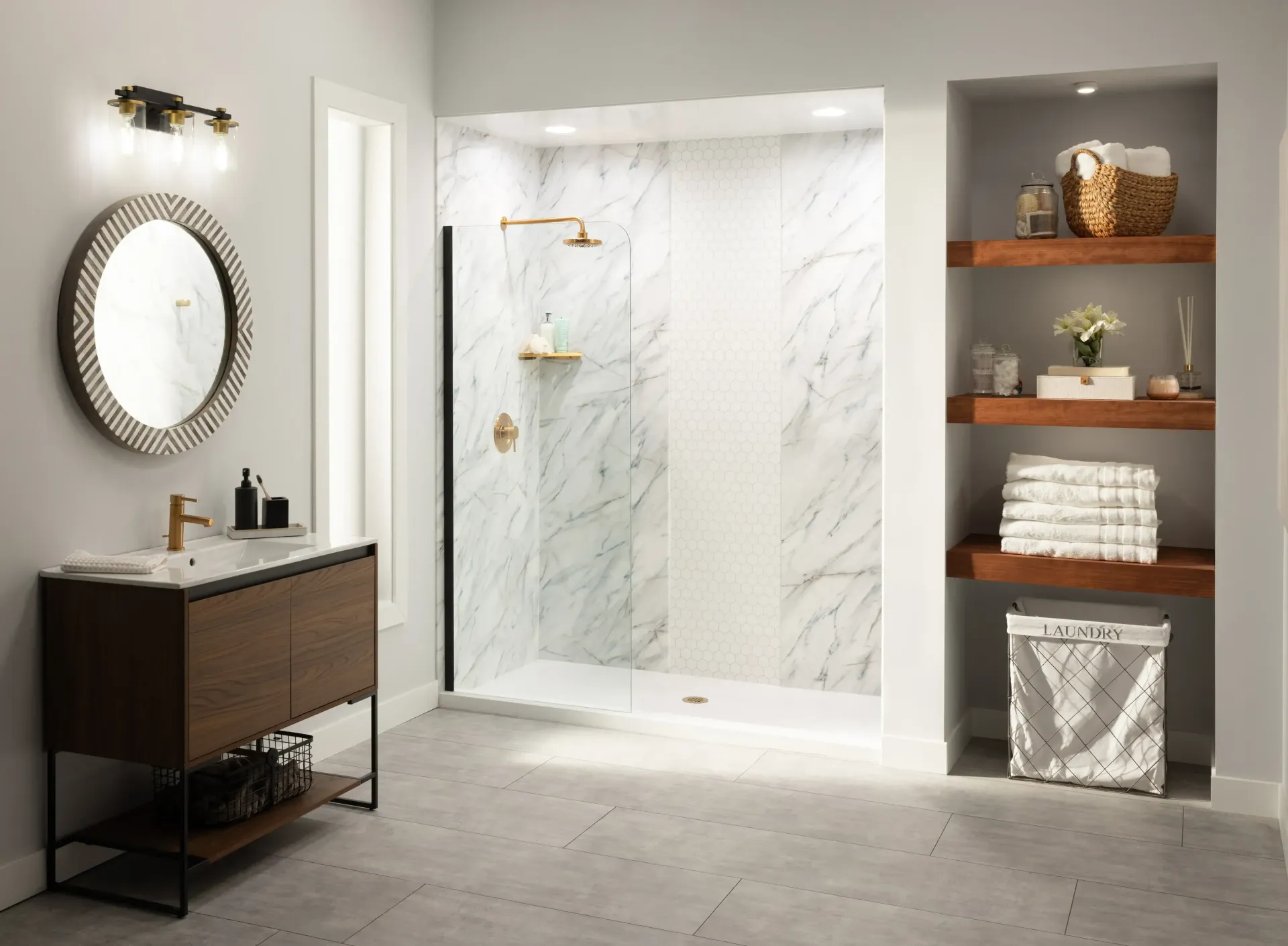Modern bathroom with marble shower, dark vanity, round mirror, and built-in shelves with towels and decor