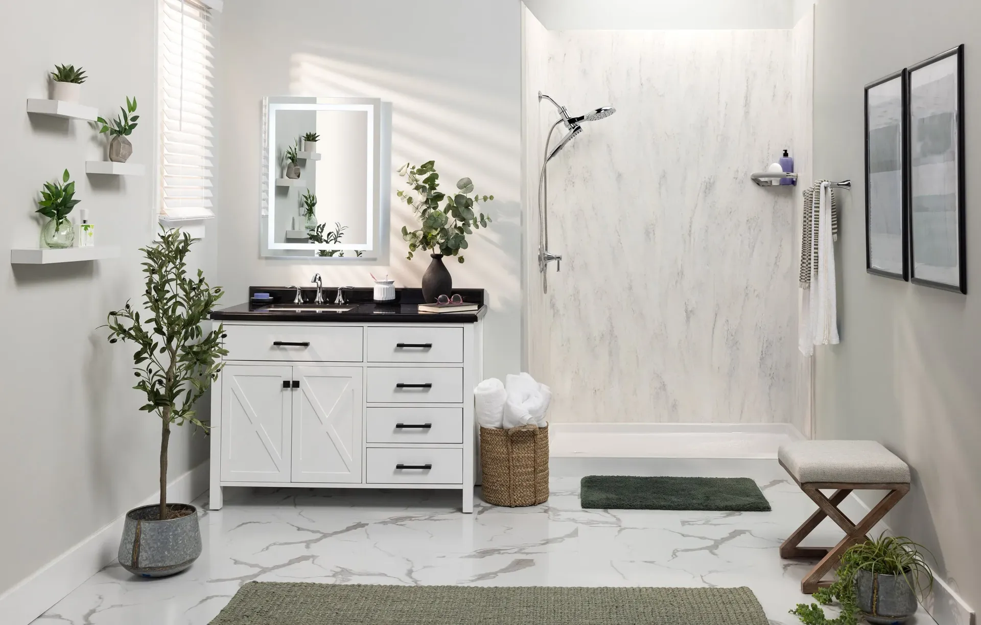 Bright white modern bathroom with double vanity, glass shower, plants, and woven basket storage