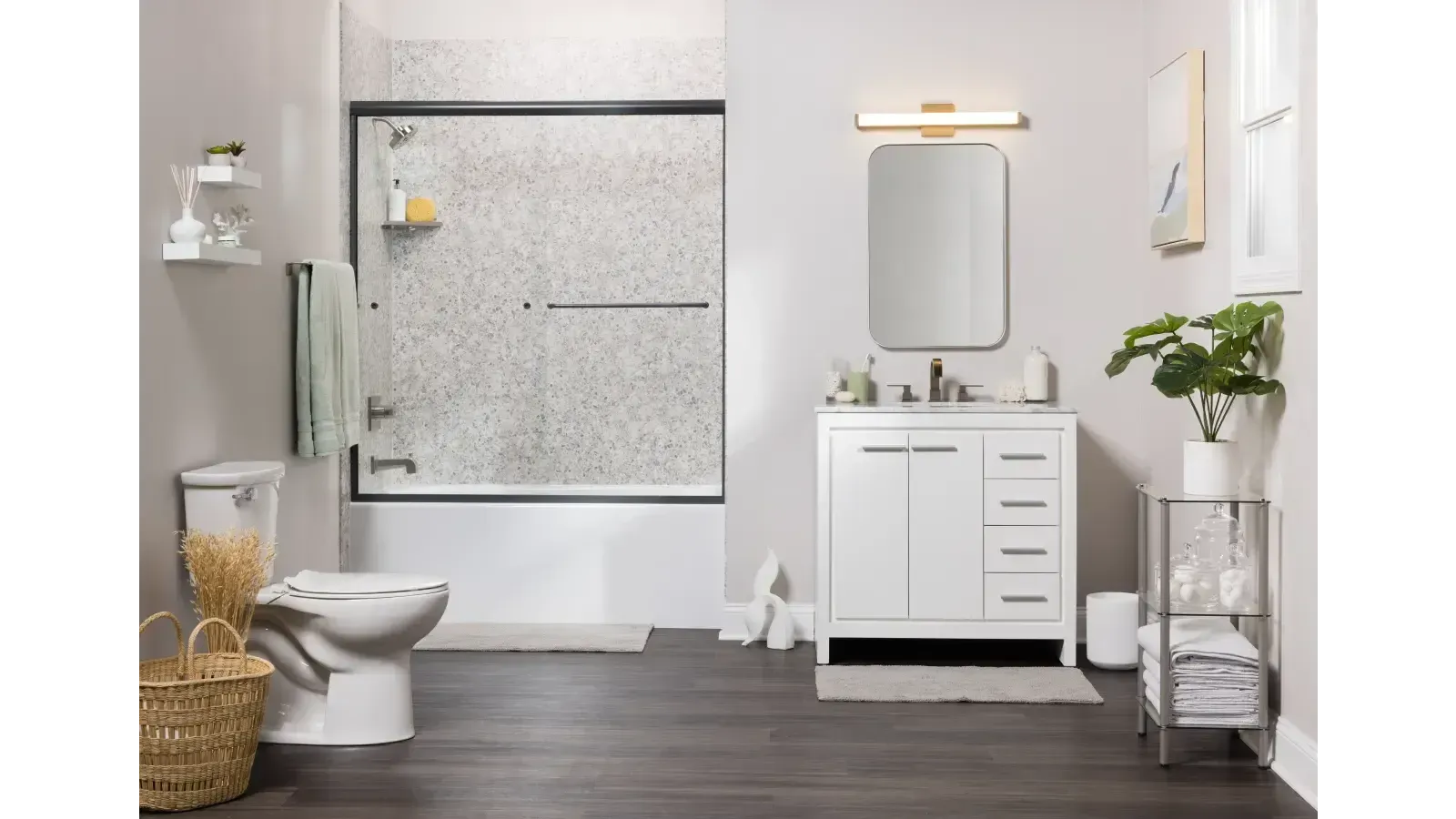 Modern bathroom with white vanity, mirror, toilet, bathtub, and dark wood floor