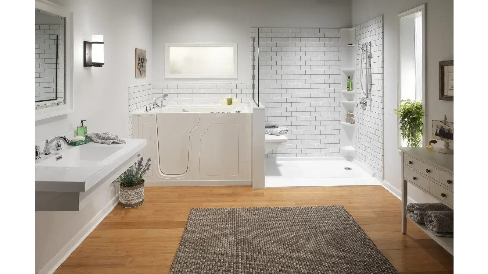 Bright white bathroom with vanity, walk-in shower, wood floor, and patterned rug.