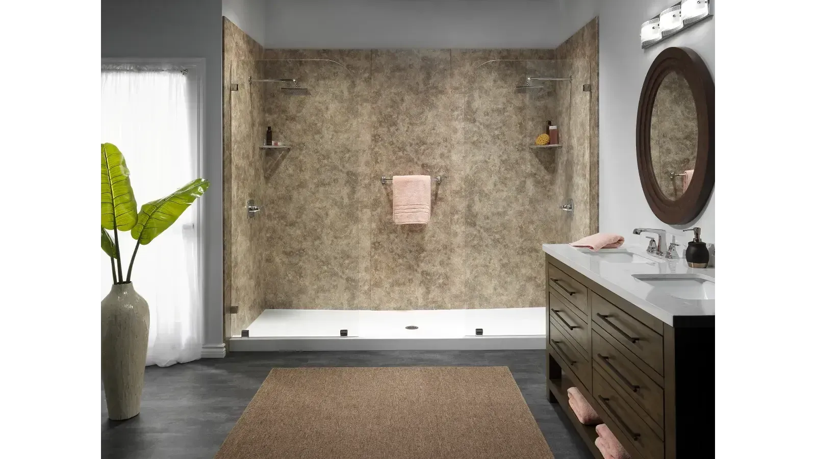Modern bathroom with stone walls, double vanity, round mirror, bathtub, and a potted plant by the window