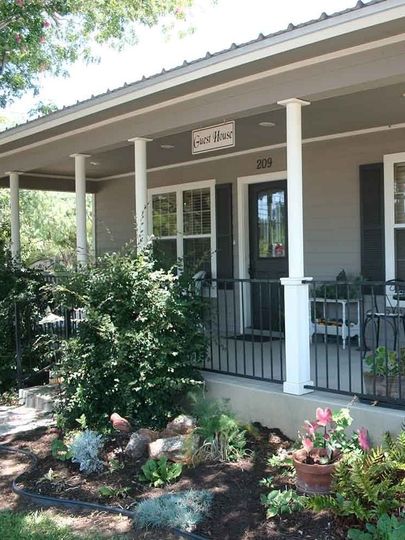 A house with a porch and a sign that says 2nd ave