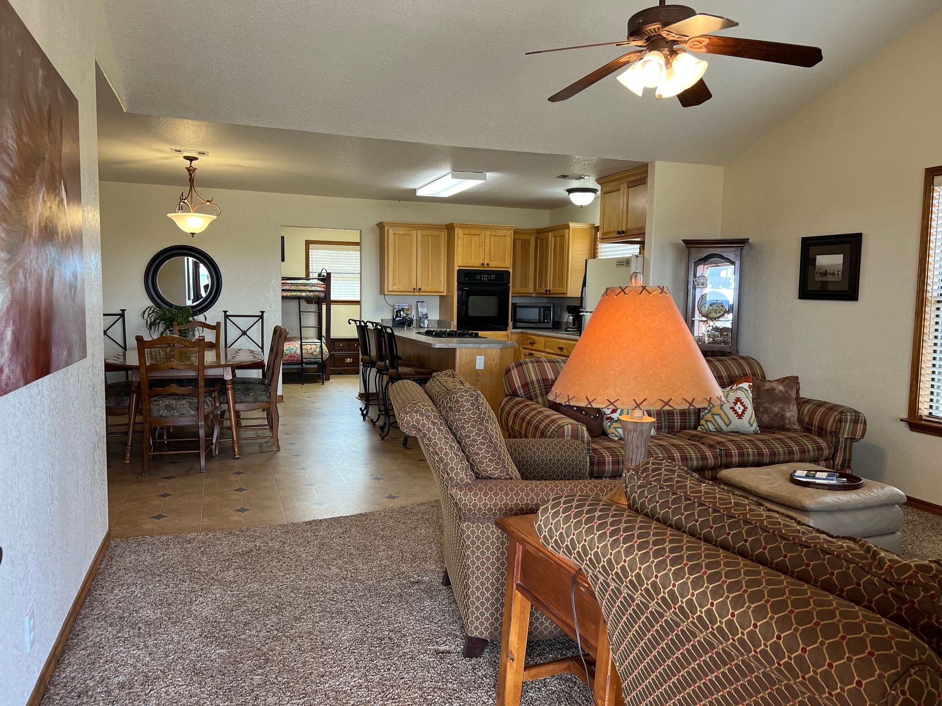 A living room filled with furniture and a ceiling fan.
