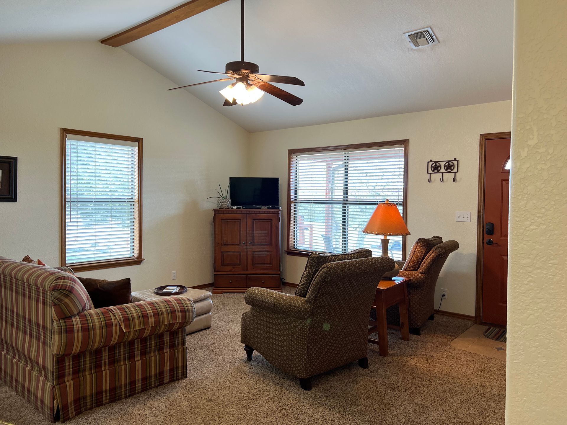 A living room with furniture and a ceiling fan