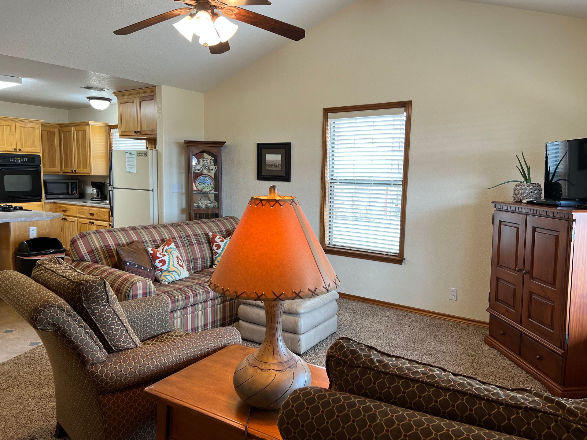 A living room with a couch and a lamp