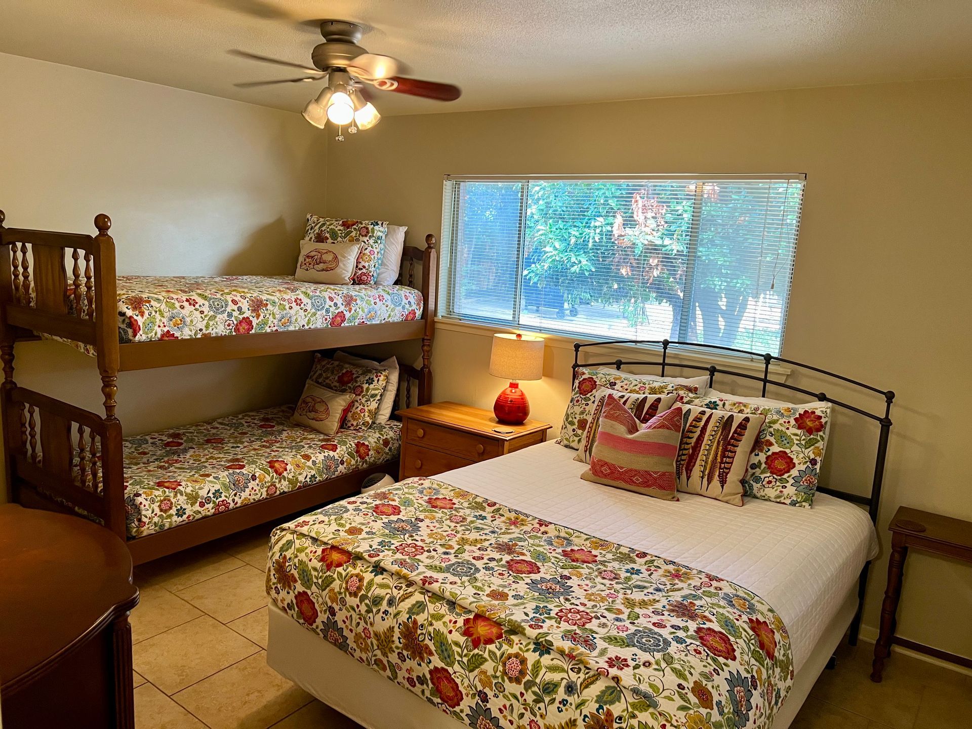 A bedroom with two beds and a ceiling fan.