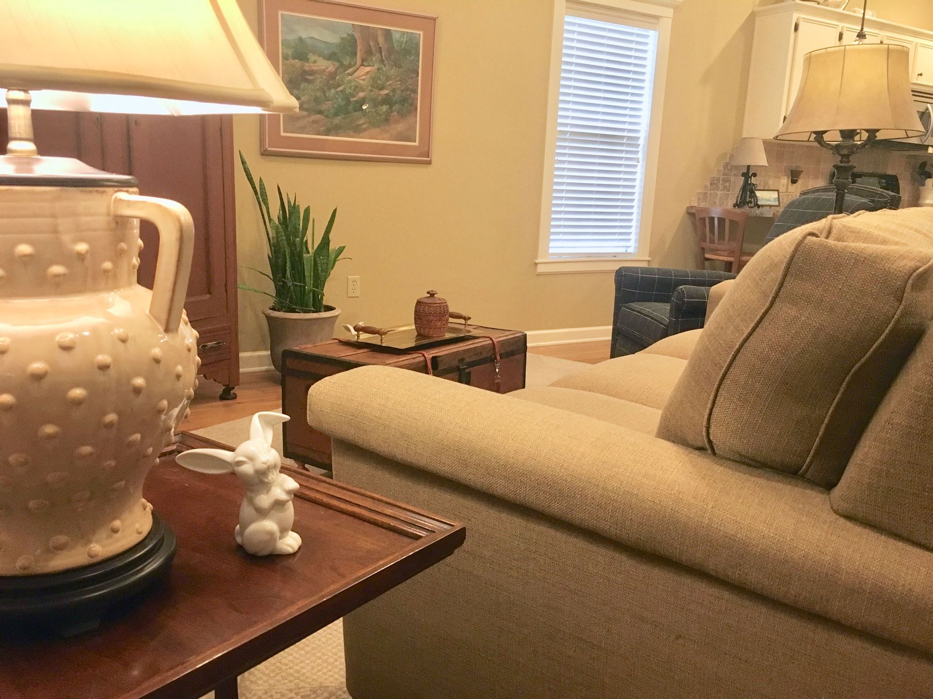 A living room with a couch and a lamp