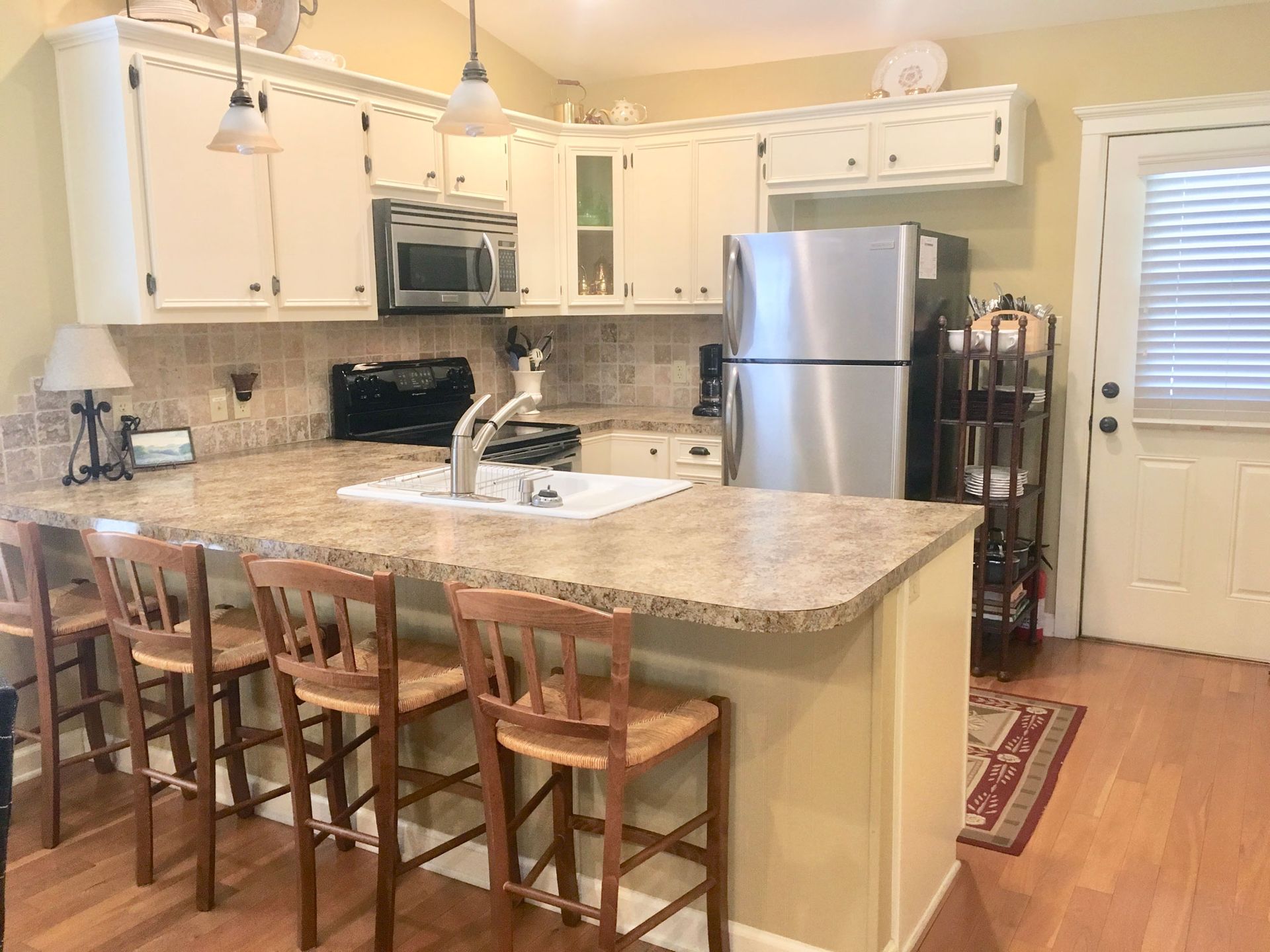 A kitchen with stainless steel appliances and granite counter tops.