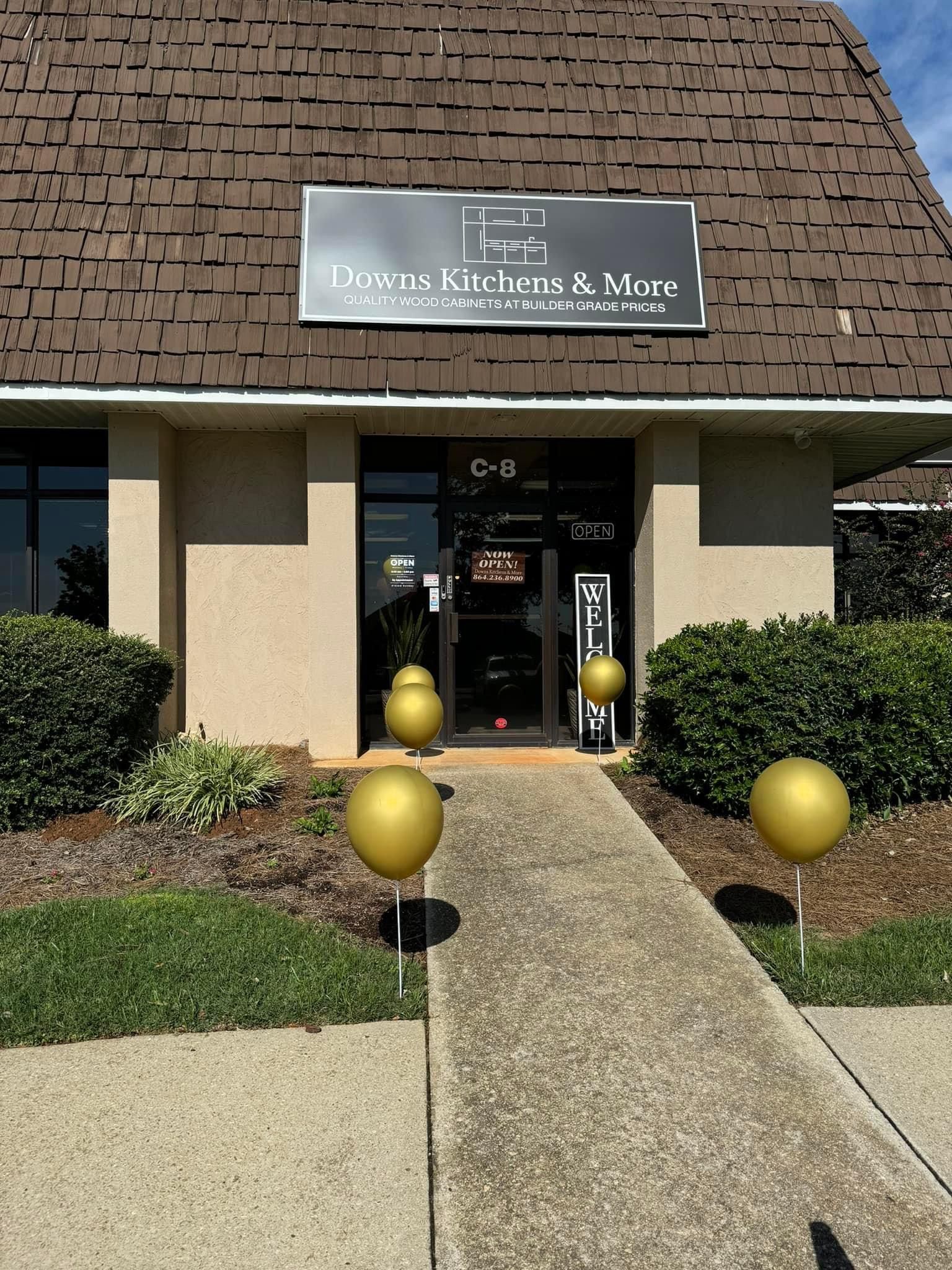 Entrance to Dawson, Kitcher & Marc law office; building with brown roof, balloons on pathway.