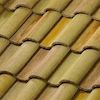 A close up of a row of tiles on a roof.