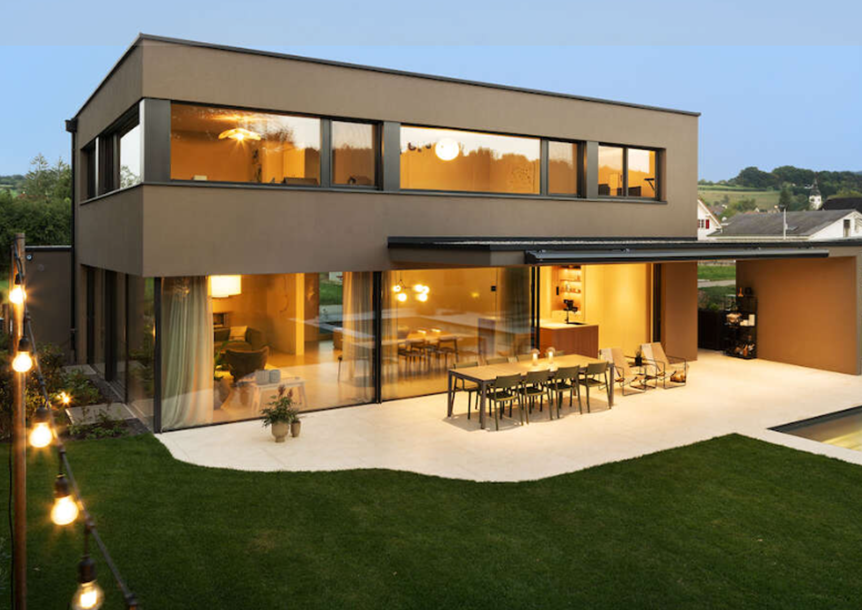 A house with a patio and a table and chairs in front of it