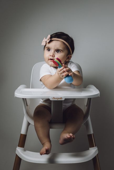 A baby chewing on a teething toy