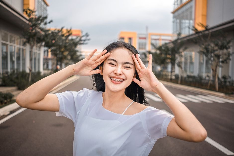 A smiling teenager wearing braces