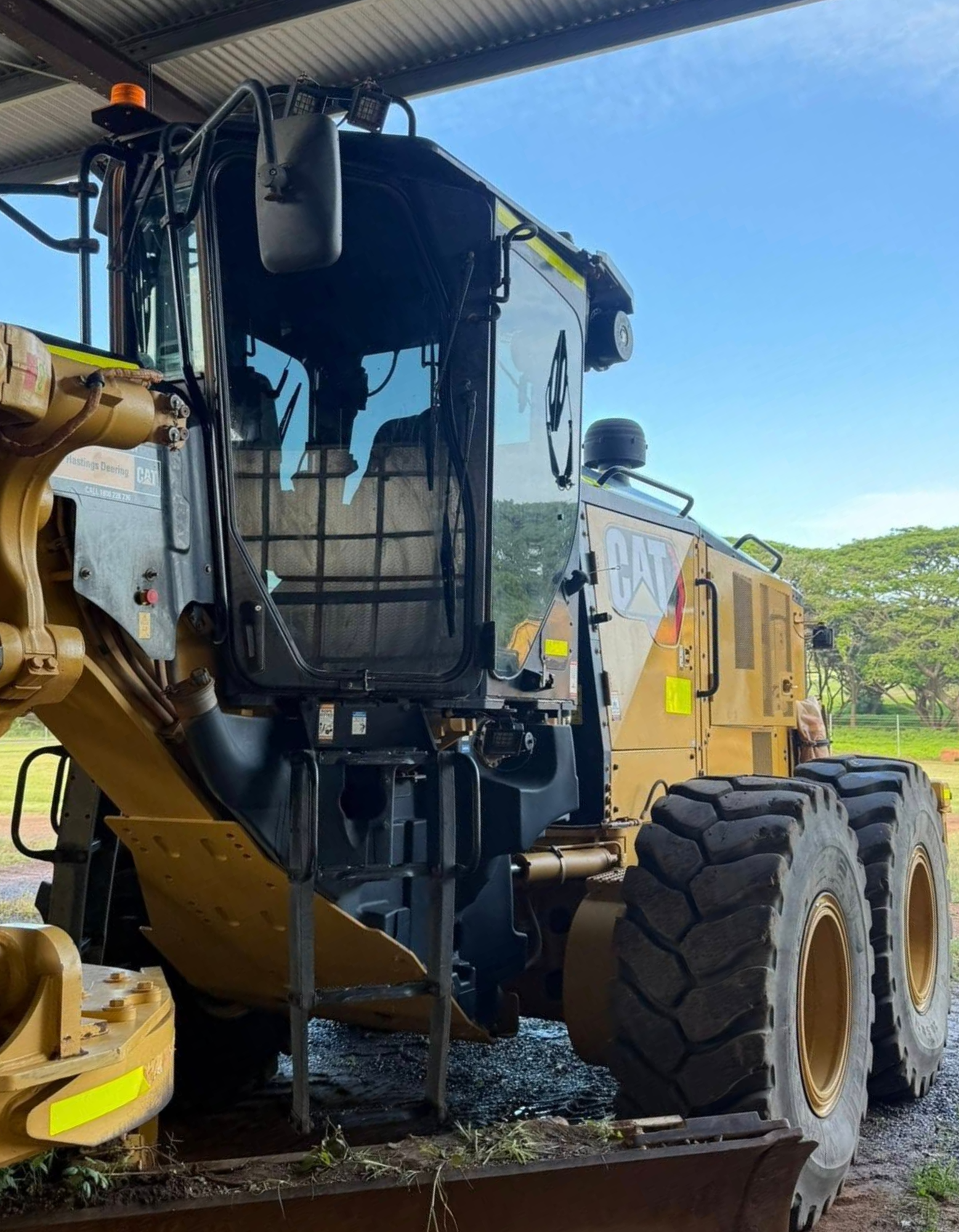 Yellow truck parked under a shelter, front cab and large tyres visible — Far North Windscreens in Mareeba, QLD