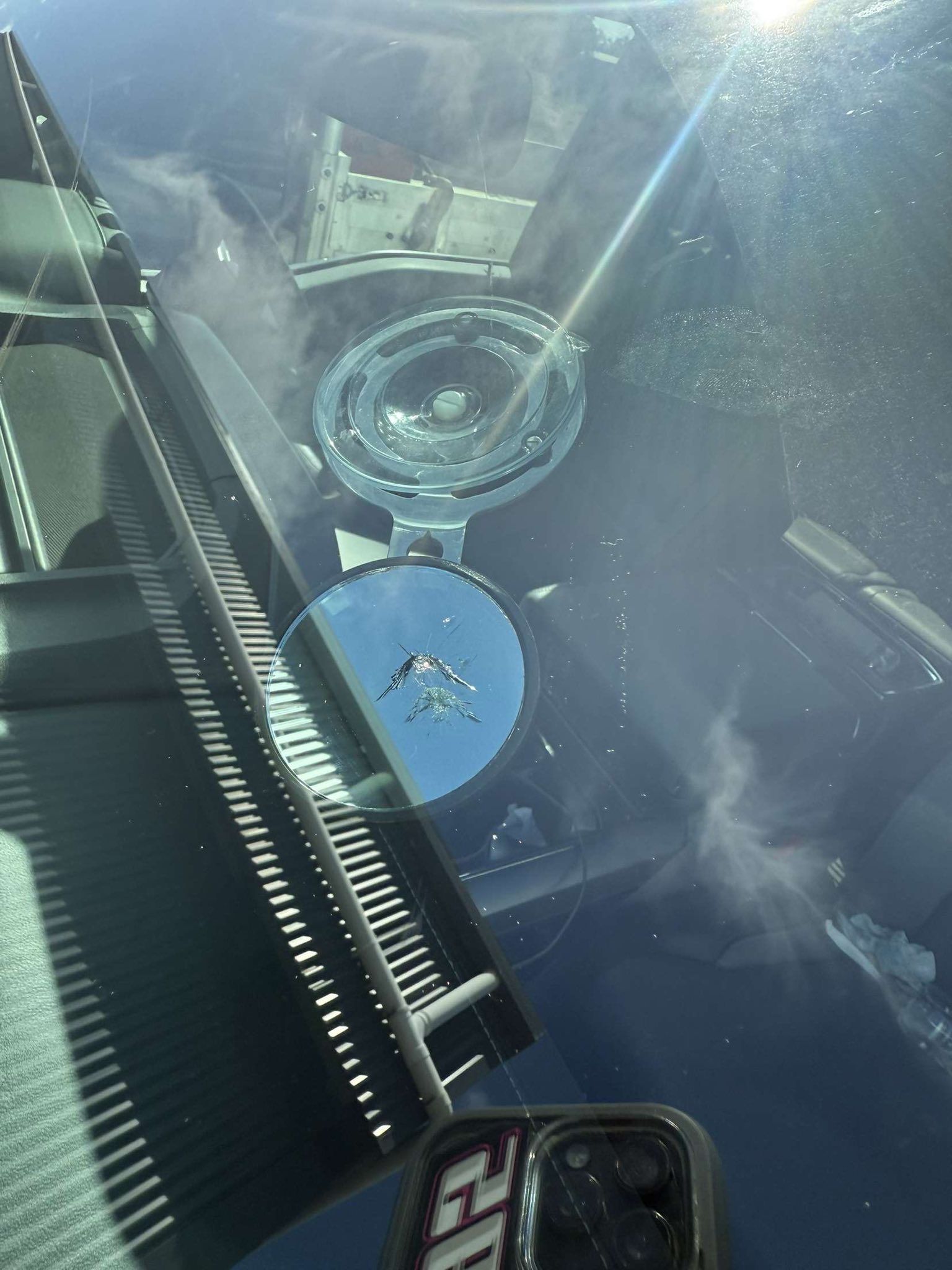 A Car Windshield With a Circular Crack and a Circular Blind-spot Mirror — Far North Windscreens in Mareeba, QLD