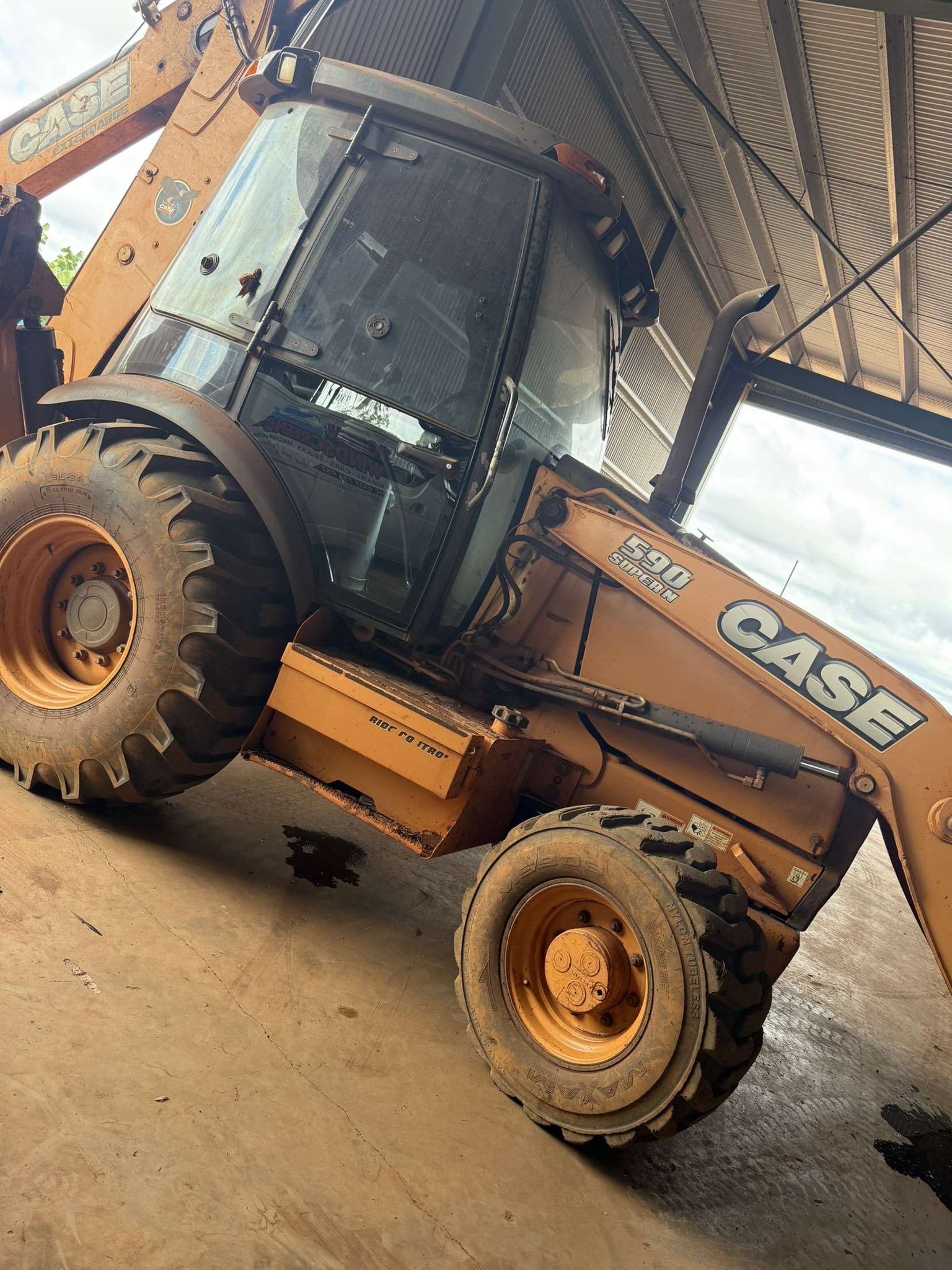 A Yellow Case Backhoe Loader Parked — Far North Windscreens in Mareeba, QLD
