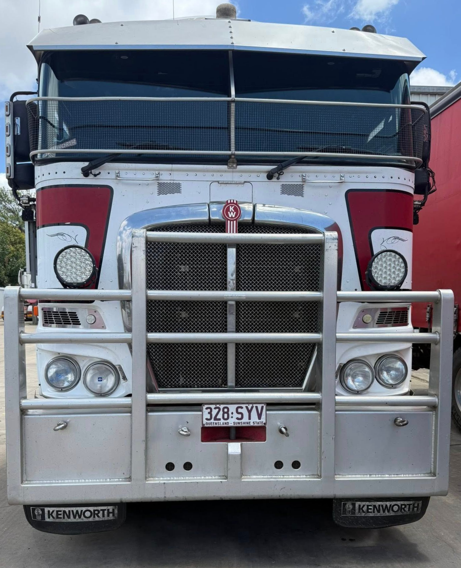 Front view of a silver and red semi-truck with a large chrome grille and headlights — Far North Windscreens in Mareeba, QLD