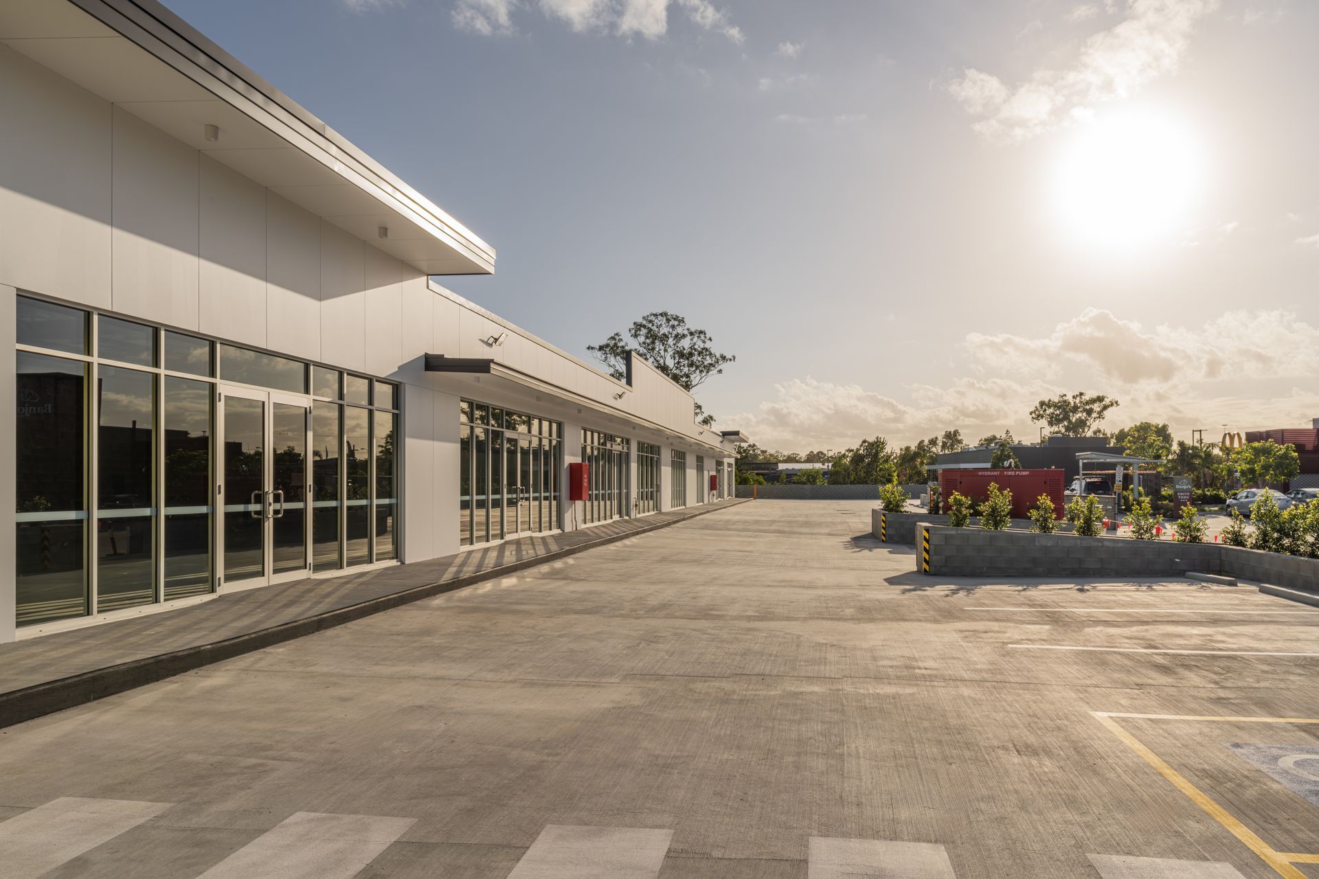 Empty parking lot beside a modern building at sunset