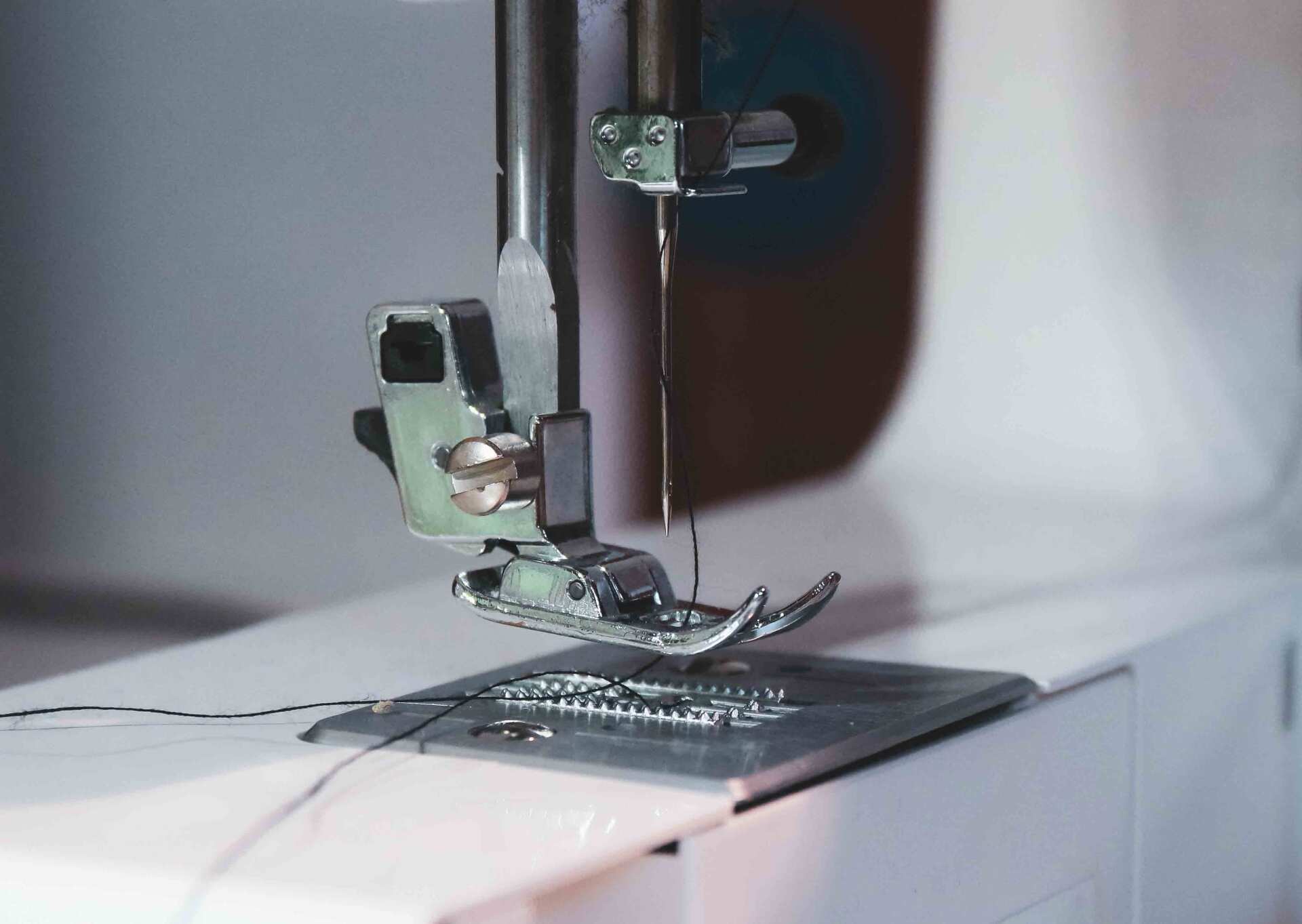 White Sewing Machine On Table — Sewing Machines in Coffs Harbour, NSW