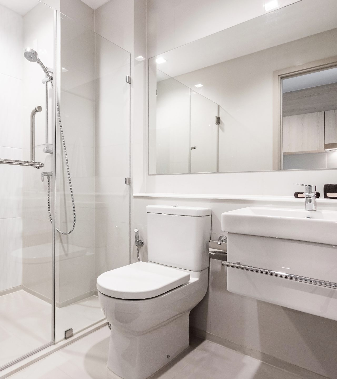 Bathroom with two white bowl sinks on a wood countertop, black faucets, mirrors, and a plant.
