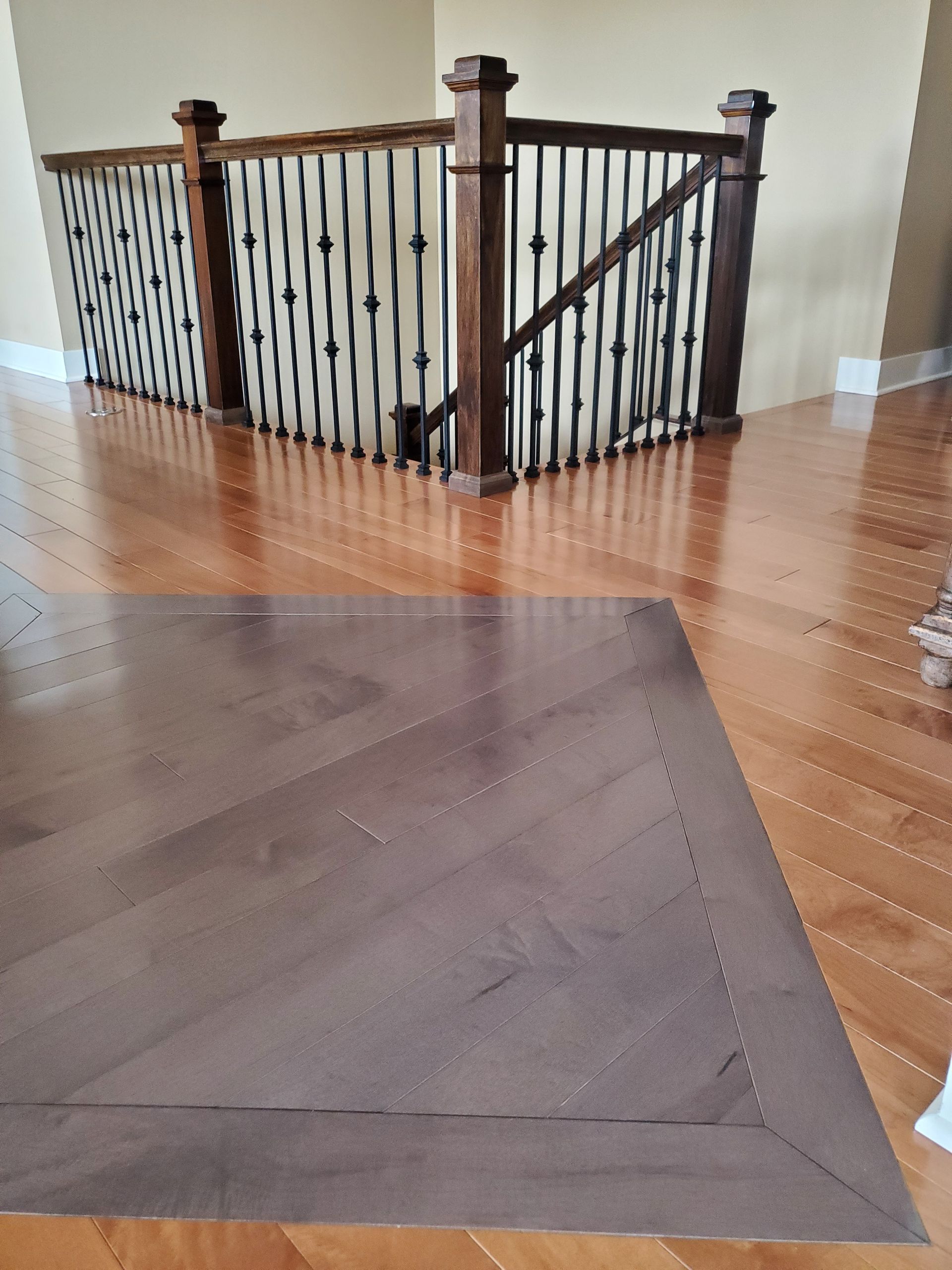 There is a Rug on the Floor in Front of a Staircase — Omaha, NE — Ohana Wood