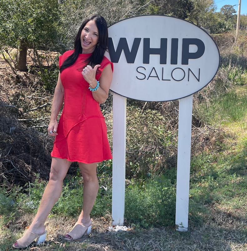 Amy reviewing a notebook with a salon owner