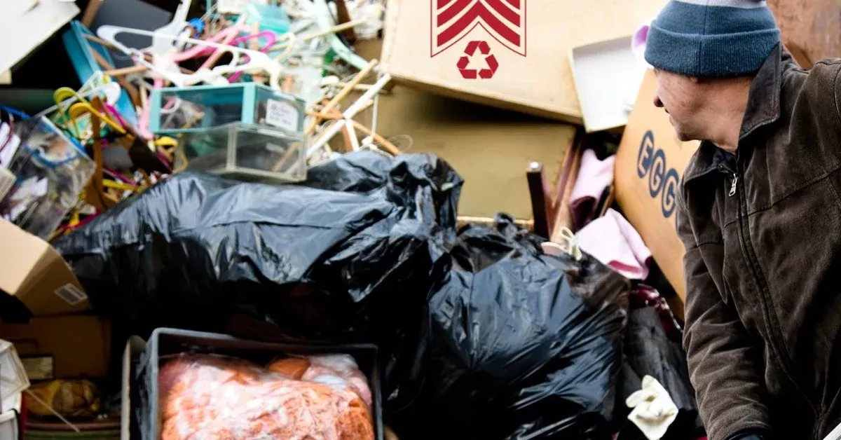 Sgt Junk-It crew member sorting junk bags and clutter during a garage cleanout in Louisville, KY