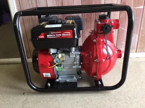 Portable red and black water pump in a black metal frame on a concrete floor