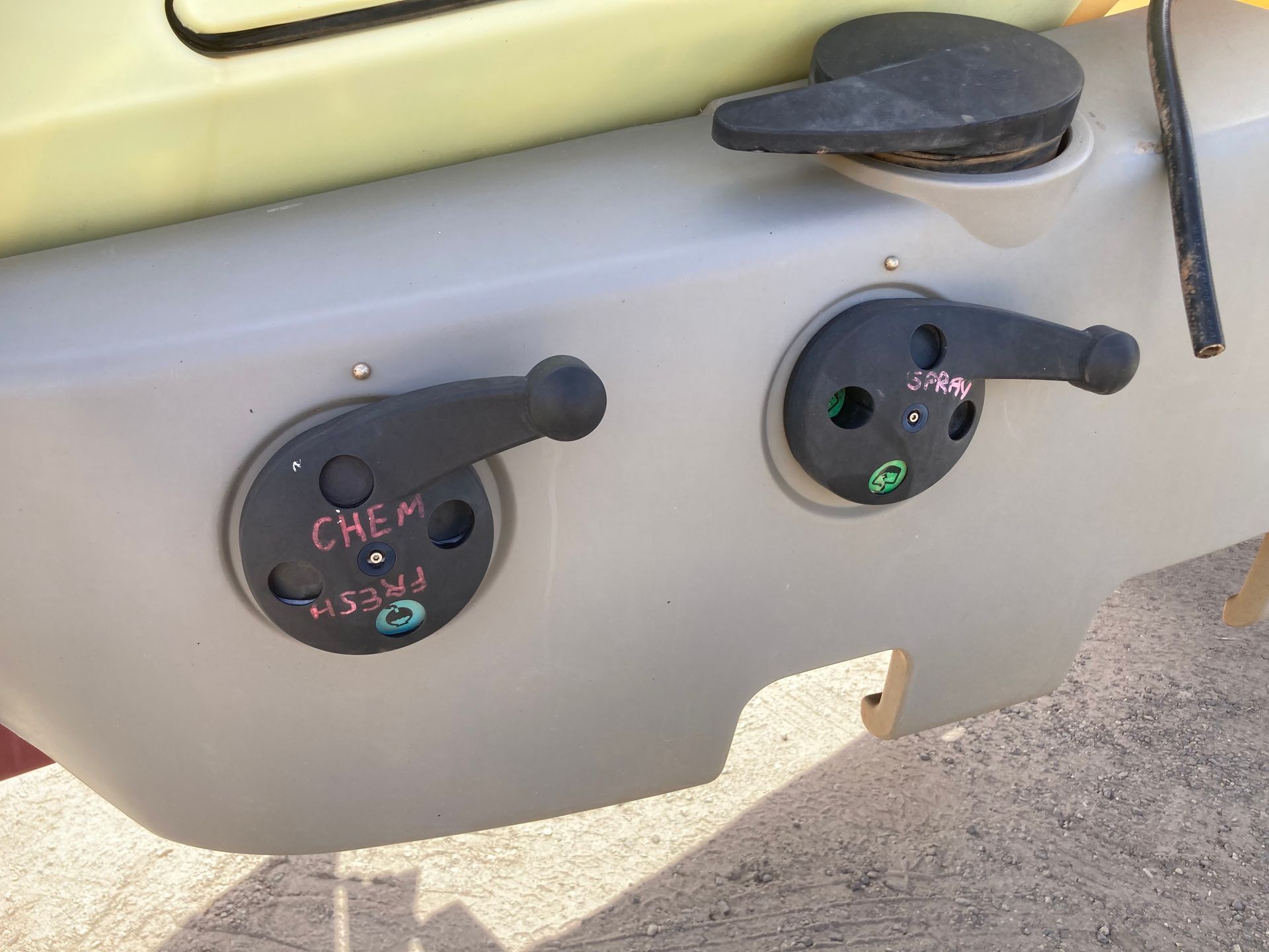 Two black dashboard controls on a gray panel with colored markings and a small shelf above