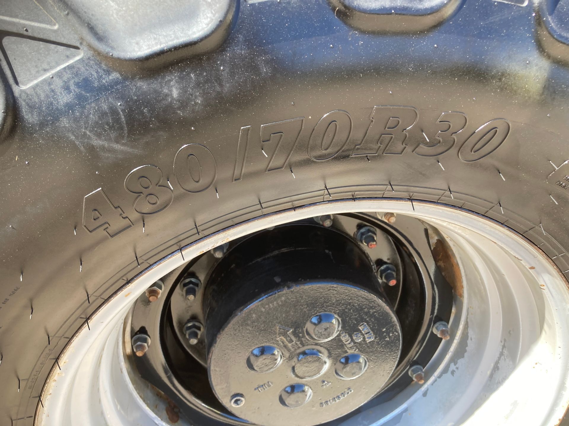 Close-up of a black tire and silver rim with embossed “ASCO 5.70-8” lettering