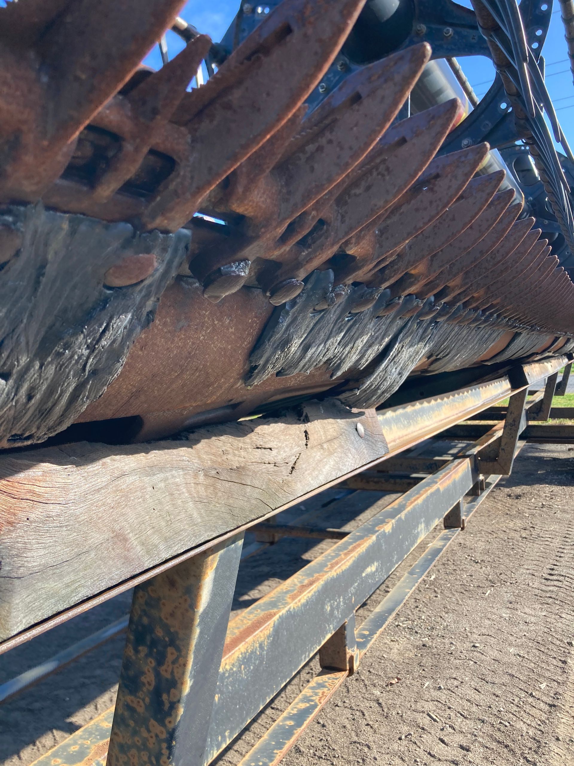Rusty metal beams stacked on a trailer in an outdoor industrial yard