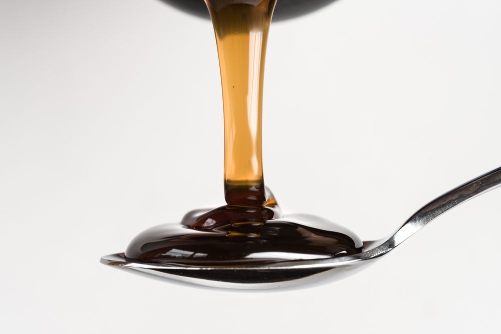 Corn syrup substitute being poured into a spoon.