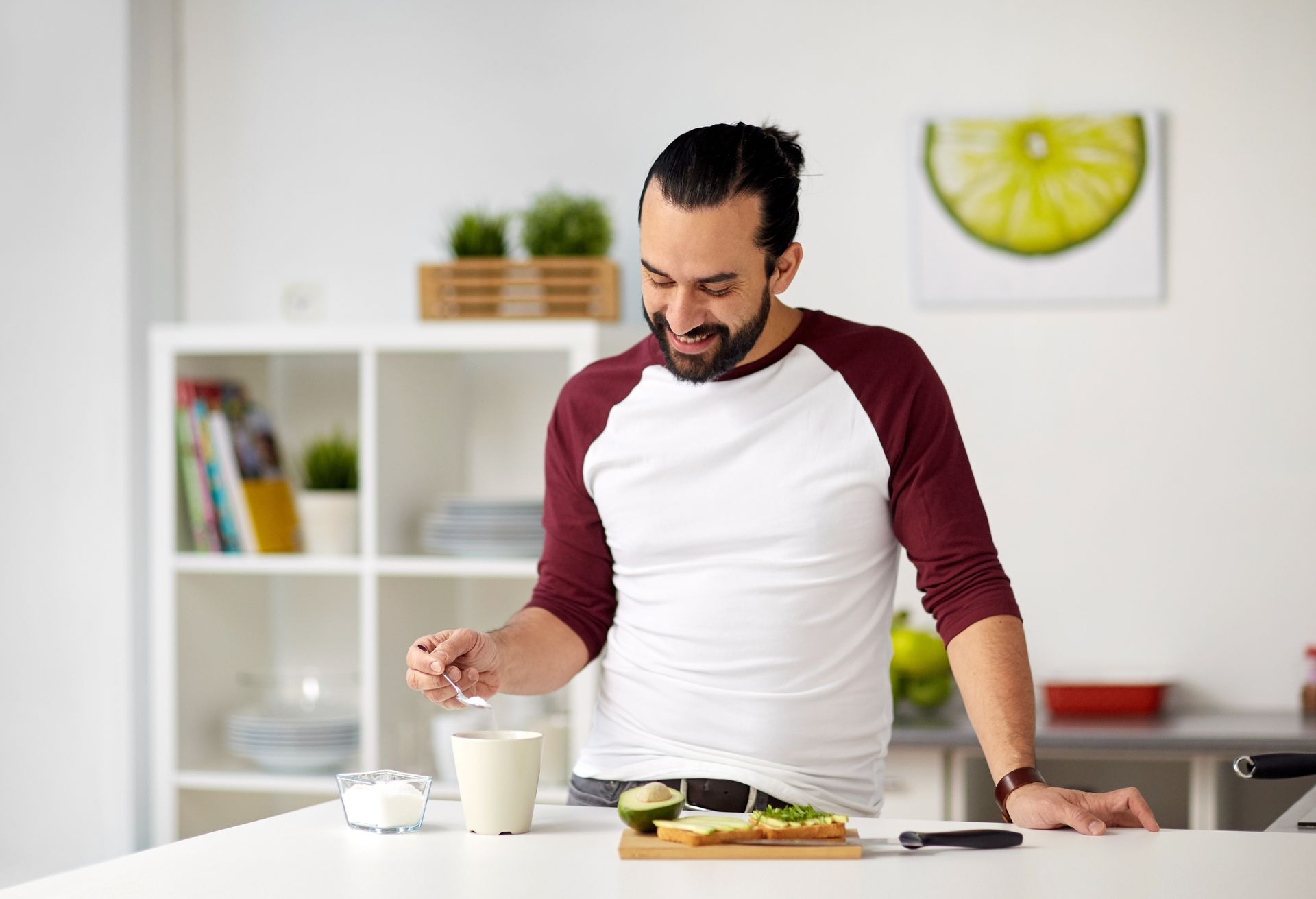 A man adds a sugar substitute to his morning tea | he is exploring Types of Sugar Alternatives and Sweeteners