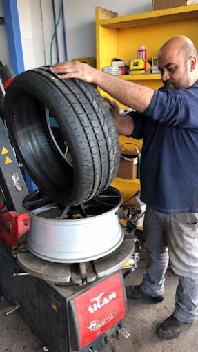 איש צוות מקצועי מבצע תיקון פנצ'ר בירושלים ומרכיב צמיג חדש על ג'אנט בעזרת מכונה ייעודית.