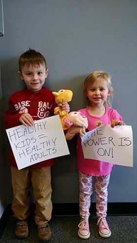 kids with sign chiropractic care
