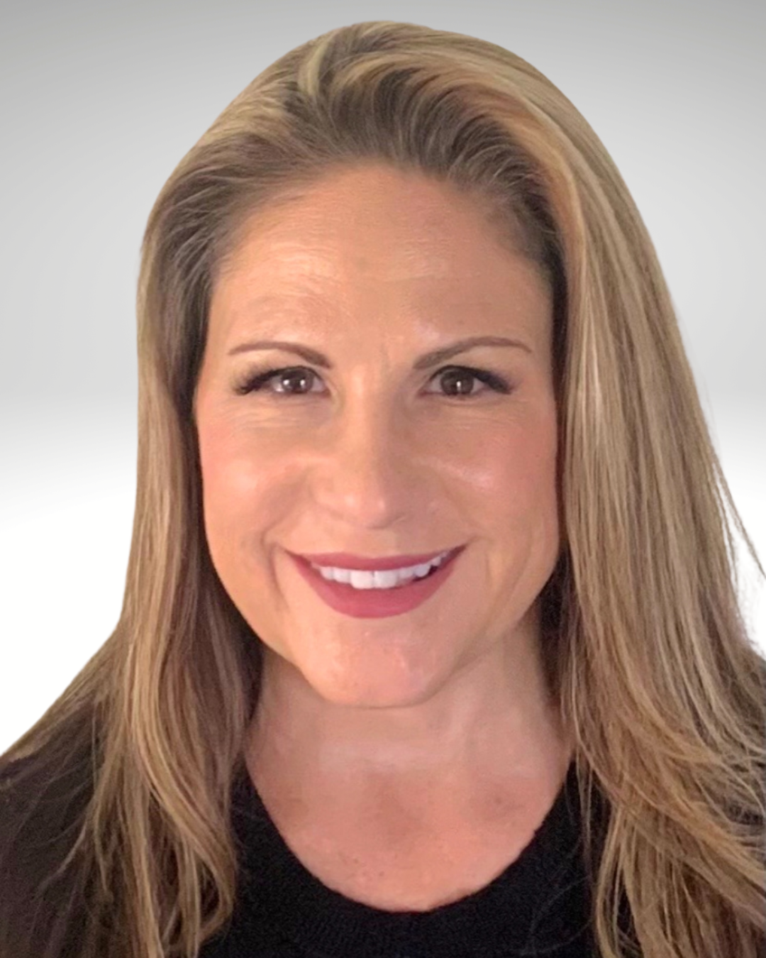 Smiling woman with blonde hair against a light gray background, wearing a black top