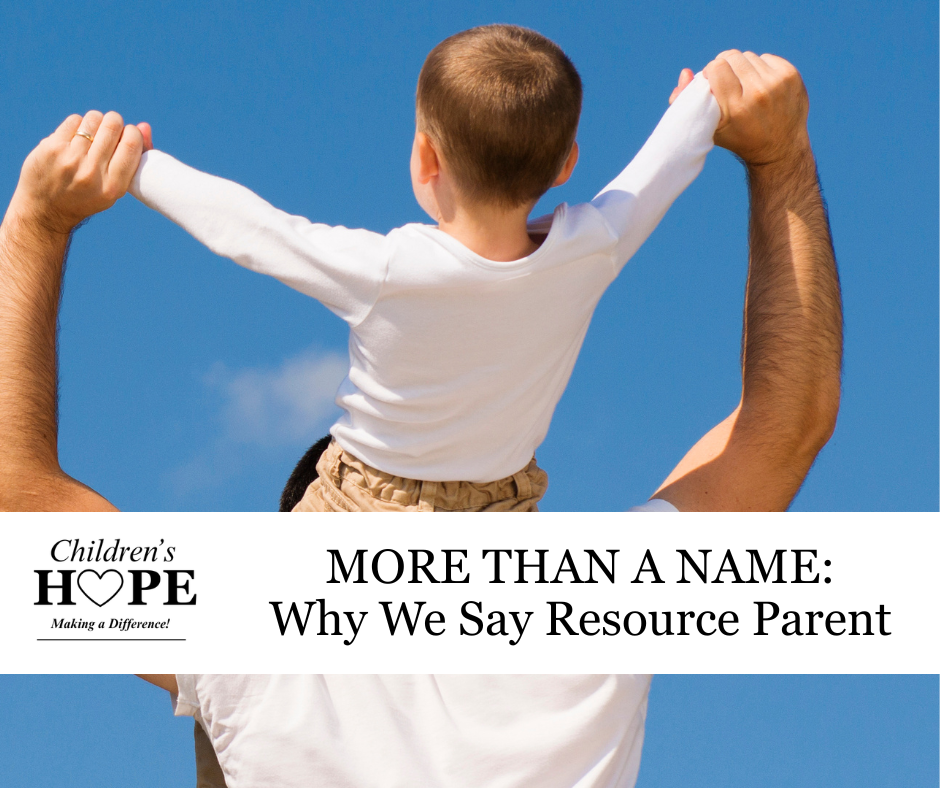Adult and child raising arms against blue sky with banner: “MORE THAN A NAME: Why We Say Resource Parent”