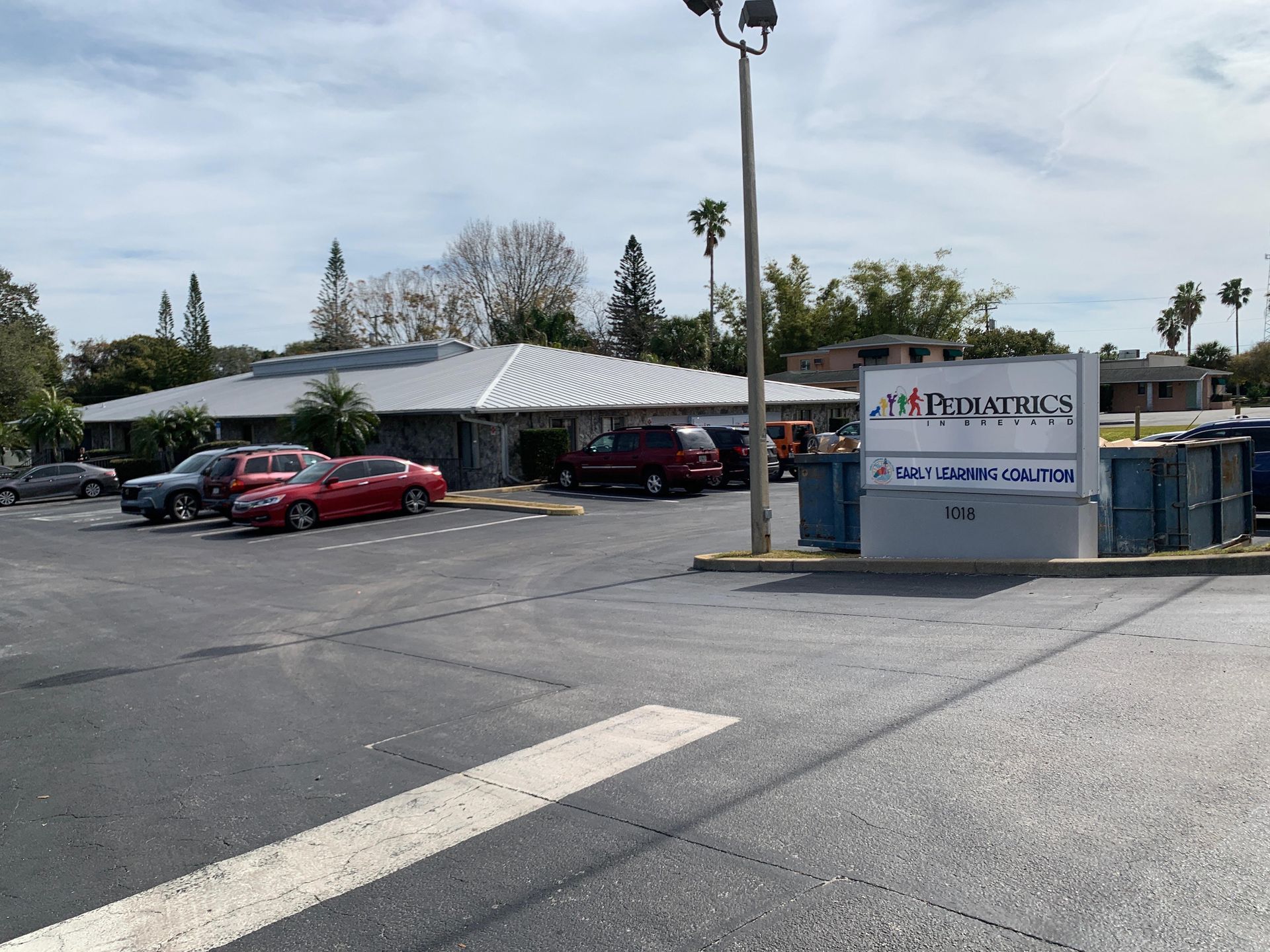 A parking lot with a sign that says pediatrics on it