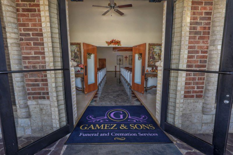 Welcoming entrance to Gamez & Sons Funeral & Cremation Services chapel with open doors, elegant décor, and seating prepared for services at funeral homes in Laredo, TX.