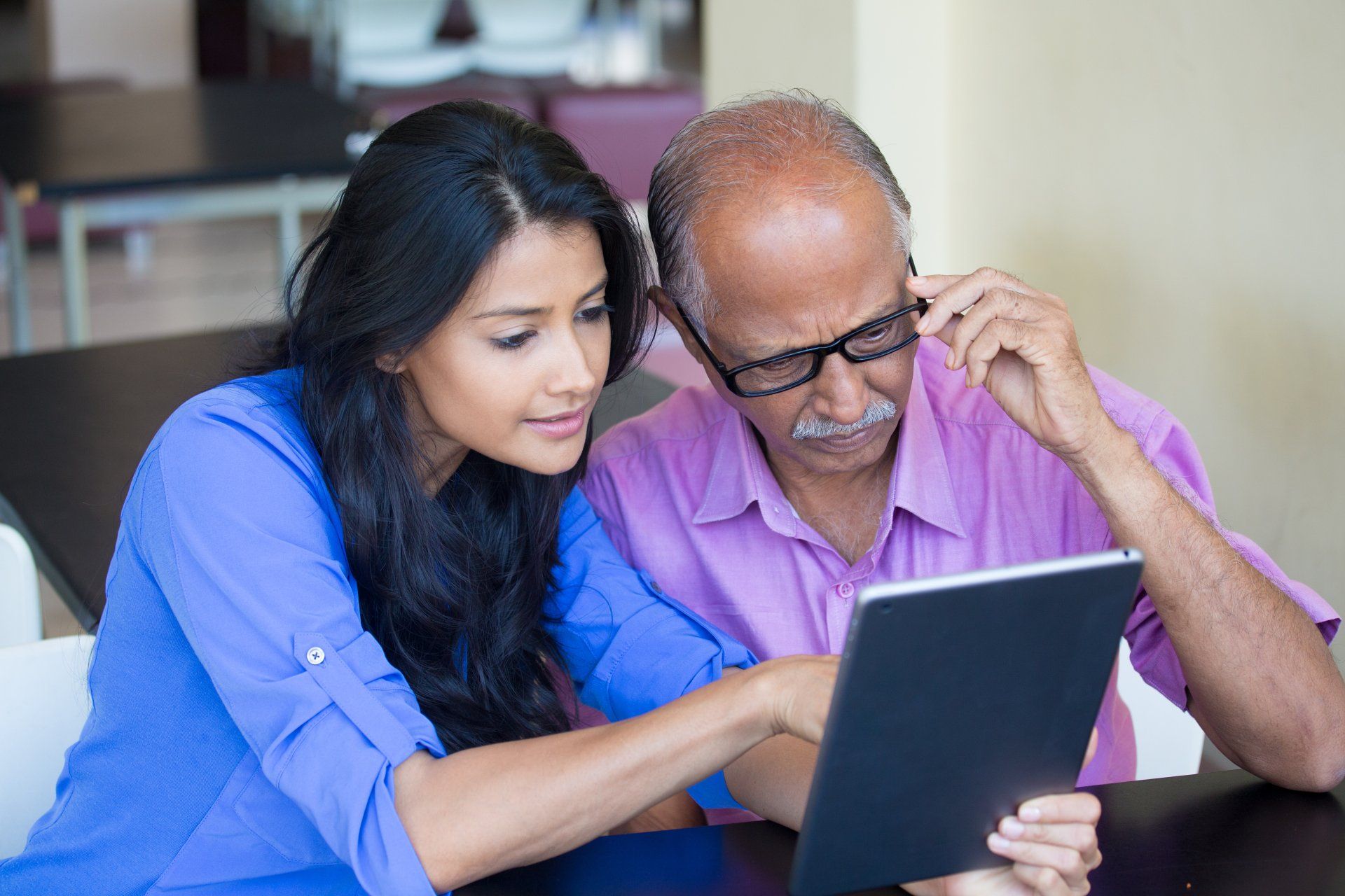 Family reviewing funeral or cremation arrangements together on a tablet