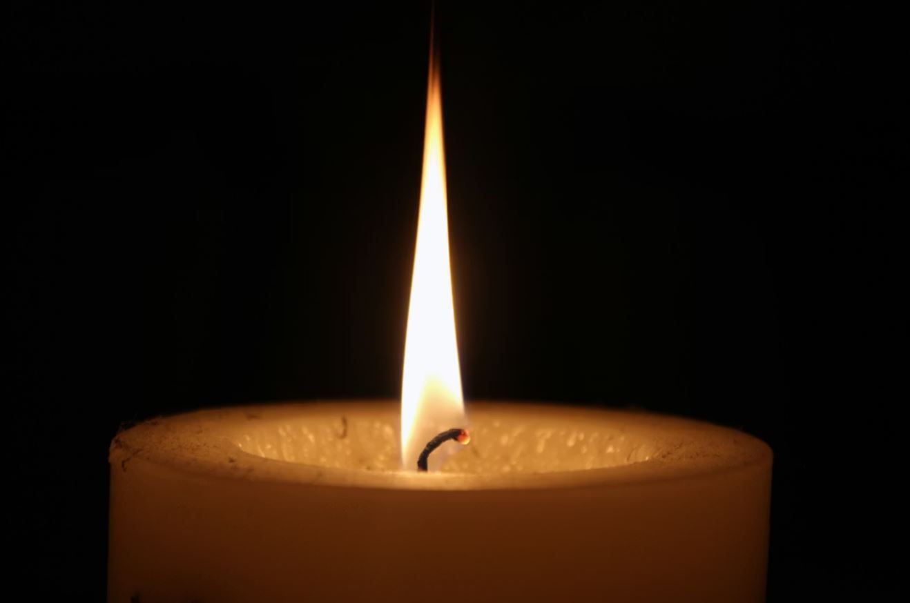 single lit candle symbolizing funeral tribute in Laredo, TX