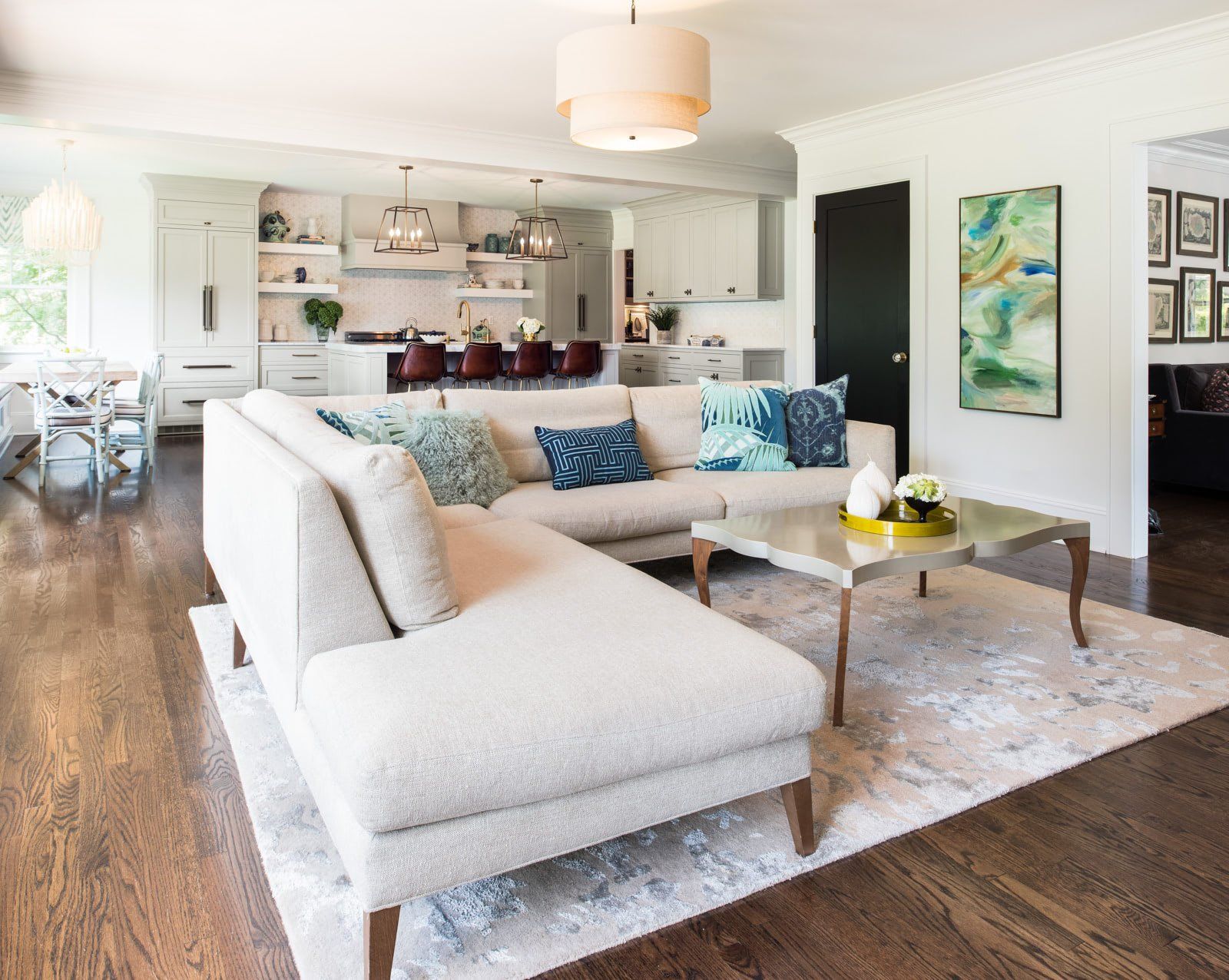 A living room with a white sectional couch and a coffee table