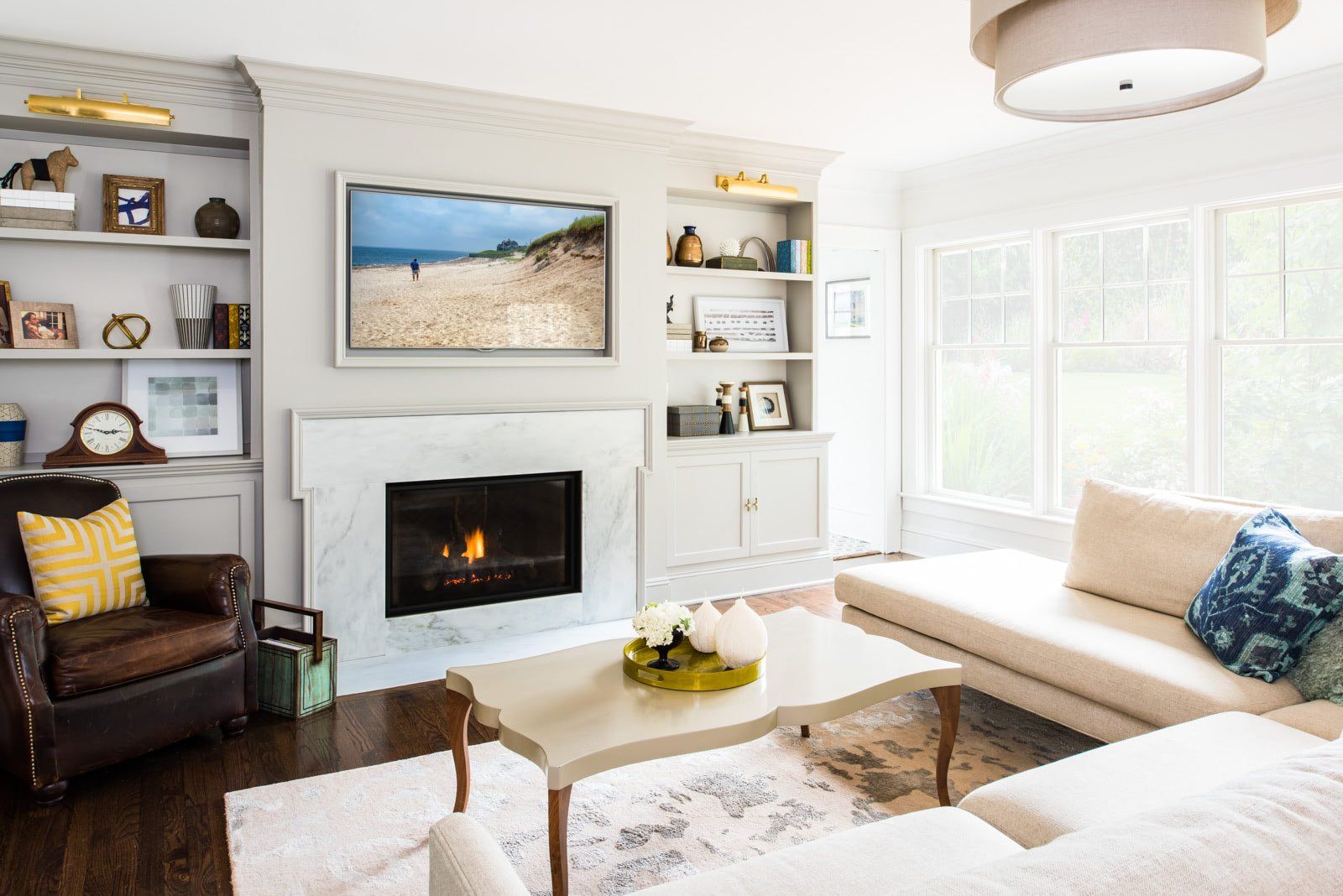 A living room with a fireplace , couch , chair and television.