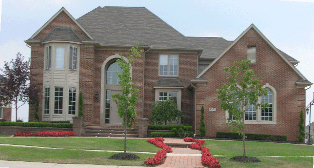 A large brick house with a walkway leading to it