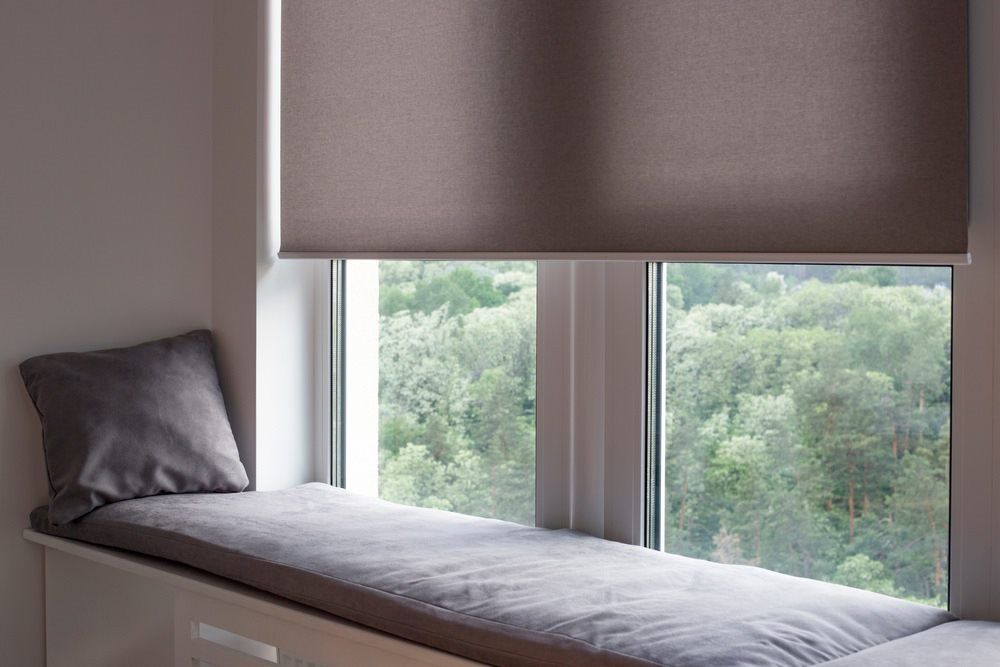 light grey roller blinds on large window
